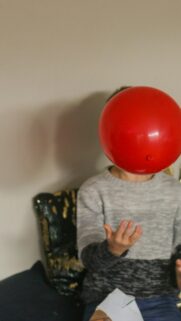 Playful Kid with Red Balloon Fun Aesthetic Mobile Wallpaper