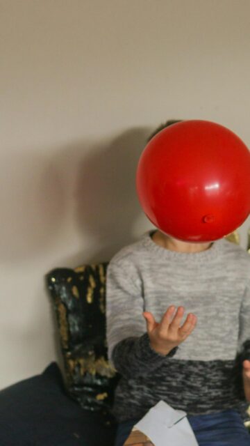 Playful Kid with Red Balloon Fun Aesthetic Mobile Wallpaper