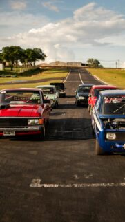 Vintage Drag Racing Cars on Starting Line Phone Wallpaper