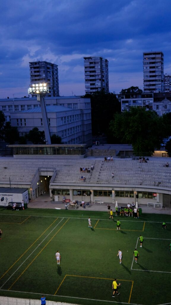 Evening Football Match at Stadium Urban Landscape Wallpaper