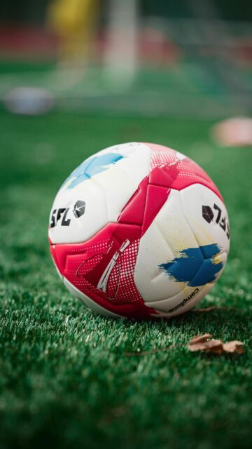 Vibrant Red and Blue Professional Soccer Ball Sports Wallpaper