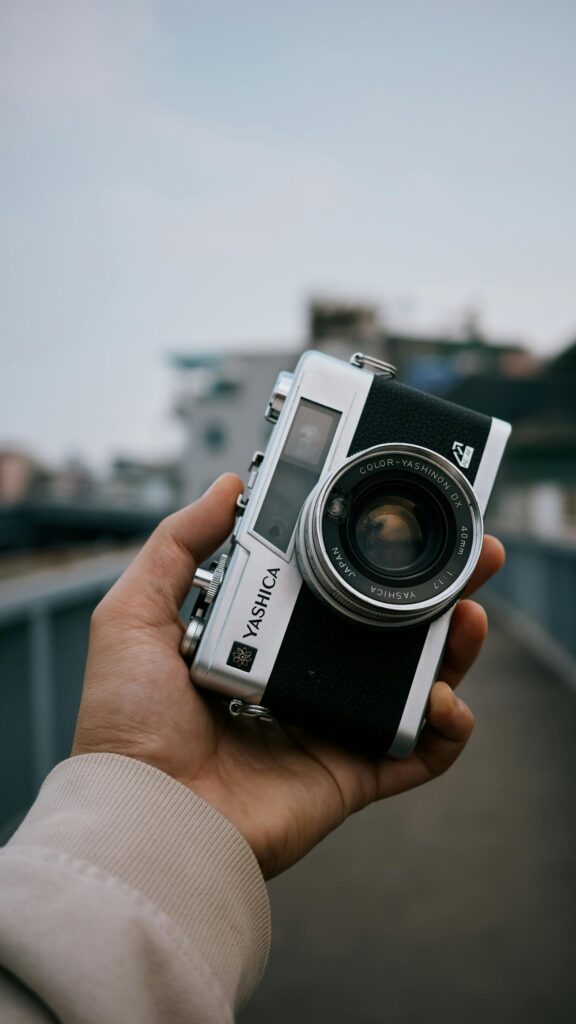 Vintage Yashica Camera in Hand Aesthetic Photography Mobile Wallpaper