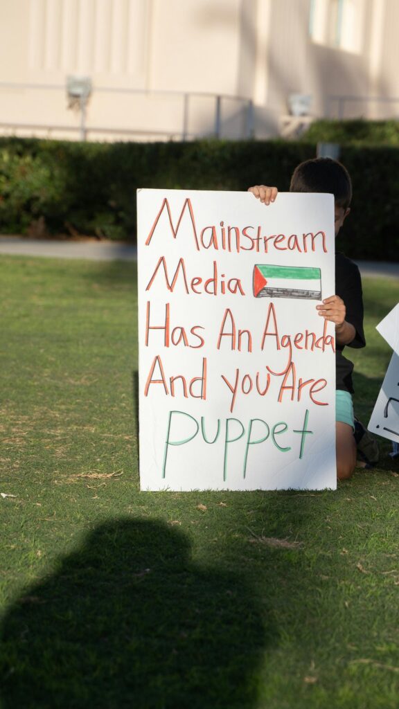 Protest Sign Featuring Palestine Flag and Social Commentary Mobile Wallpaper
