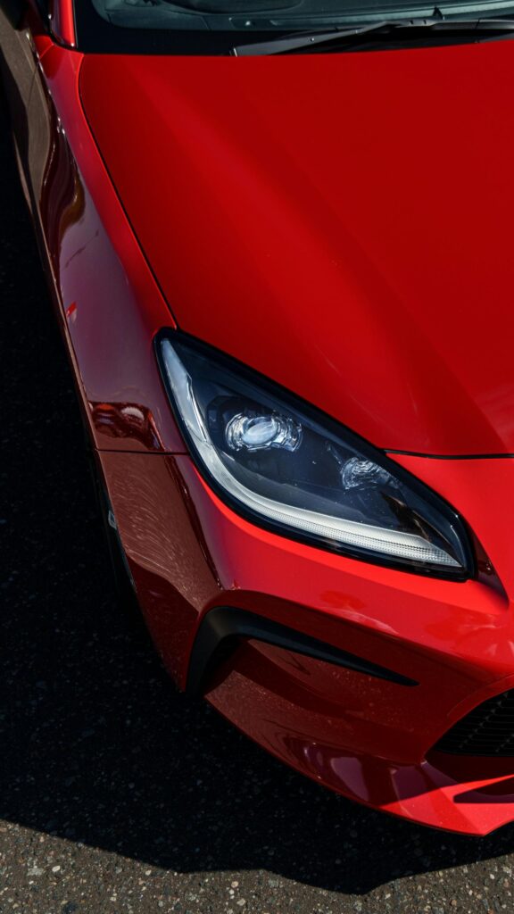 Red Sports Car Headlight Close-up 4K Phone Wallpaper
