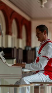 Pianist in Vintage White and Red Costume Phone Wallpaper