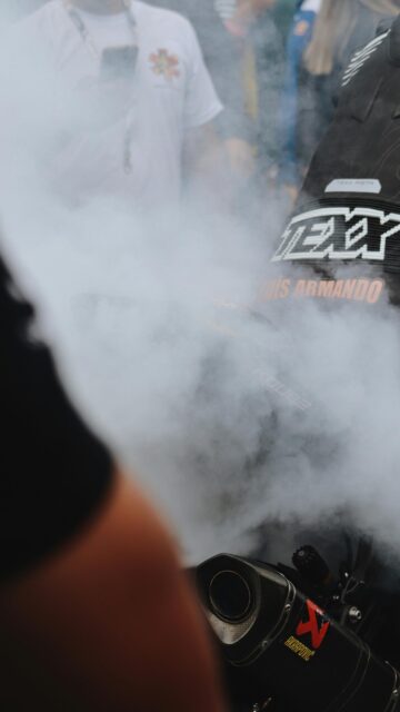 Thrilling Motorbike Exhaust Smoke Performance Mobile Wallpaper