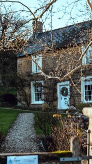 Rustic English Stone Cottage with Wreath Mobile Wallpaper