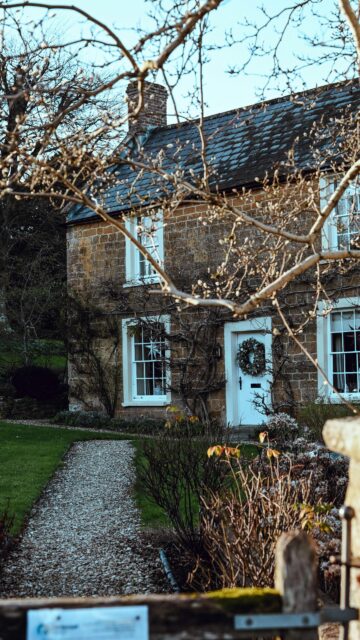 Rustic English Stone Cottage with Wreath Mobile Wallpaper