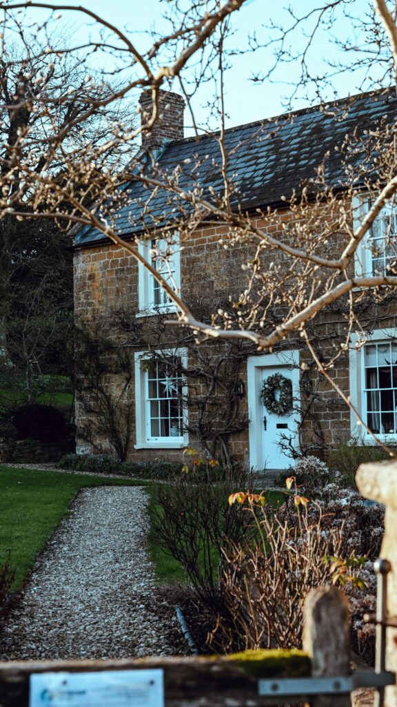 Rustic English Stone Cottage with Wreath Mobile Wallpaper
