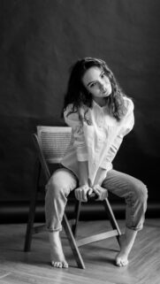 Stunning Black and White Portrait of a Girl Sitting on a Chair Wallpaper