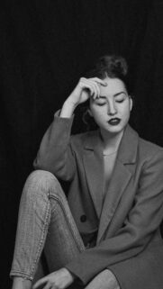 Stunning Portrait of a Stylish Woman in Blazer and Jeans Mobile Wallpaper