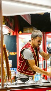 Turkish Ice Cream Vendor Professional Serving Traditional Dessert Mobile Wallpaper