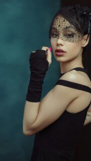 Mysterious Woman in Black Veil and Fashionable Attire Phone Wallpaper