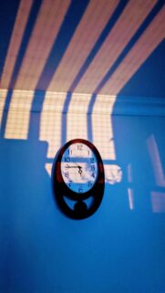 Abstract Blue Wall Clock with Dramatic Light Rays Mobile Wallpaper