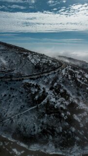 Snowy Mountain Road Above Clouds Aerial View Mobile Wallpaper