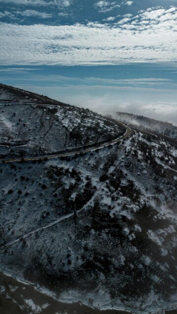 Snowy Mountain Road Above Clouds Aerial View Mobile Wallpaper