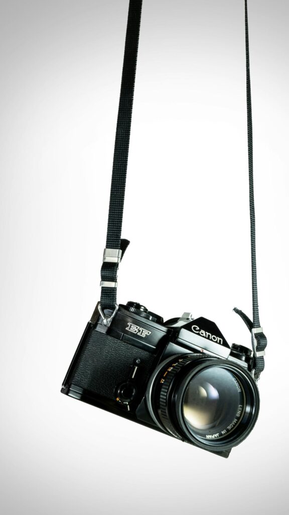 Vintage Canon EF Film Camera Hanging on Strap Mobile Wallpaper