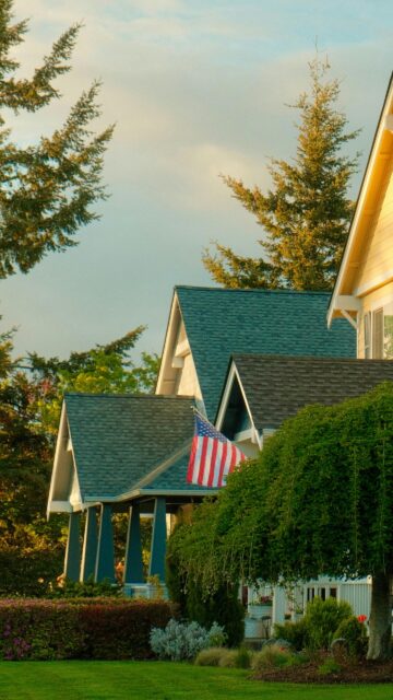Charming Suburban American Home with Flag Mobile Wallpaper