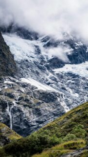 Majestic Glacier Mountain Peak with Cascading Waterfall Mobile Wallpaper