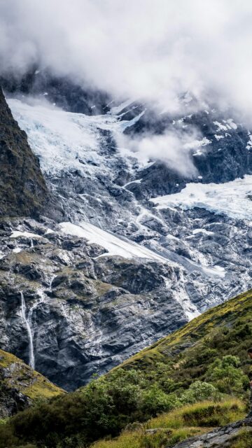 Majestic Glacier Mountain Peak with Cascading Waterfall Mobile Wallpaper