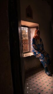 Middle Eastern Woman Sitting by Window Light Portrait Wallpaper