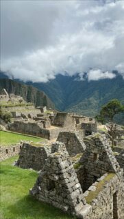 Ancient Machu Picchu Ruins Under Cloud-Covered Andean Peaks Wallpaper