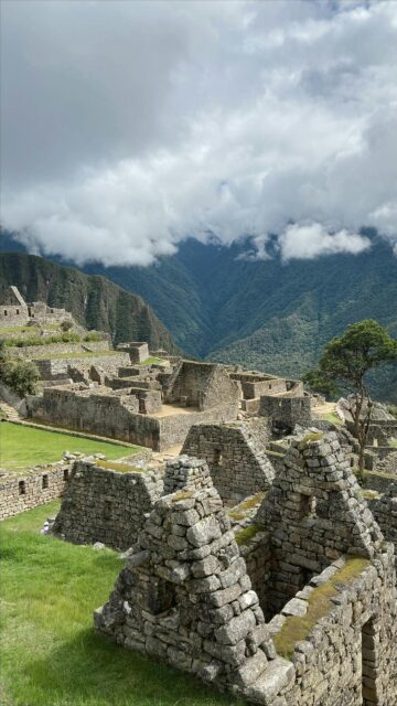 Ancient Machu Picchu Ruins Under Cloud-Covered Andean Peaks Wallpaper