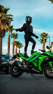 Biker Girl Standing on a Bright Green Kawasaki Ninja Sportbike Wallpaper
