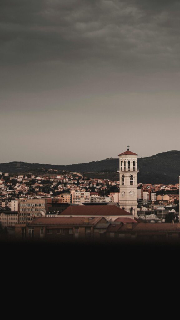 Stunning Pristine Clock Tower in Pristina City Landscape Wallpaper