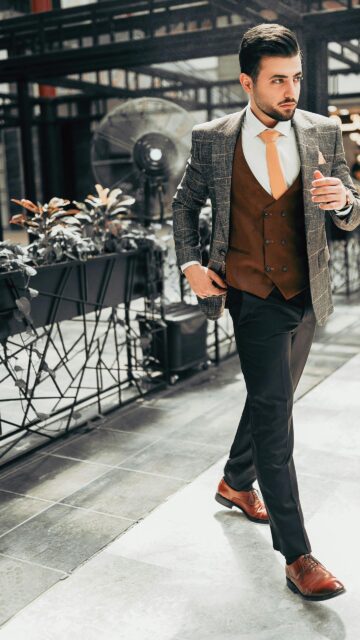 Elegant Man in Brown Suit Vest and Plaid Blazer Mobile Wallpaper