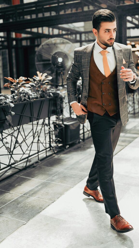 Elegant Man in Brown Suit Vest and Plaid Blazer Mobile Wallpaper