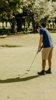 Focused Golfer Putting on Green High-Resolution Mobile Wallpaper