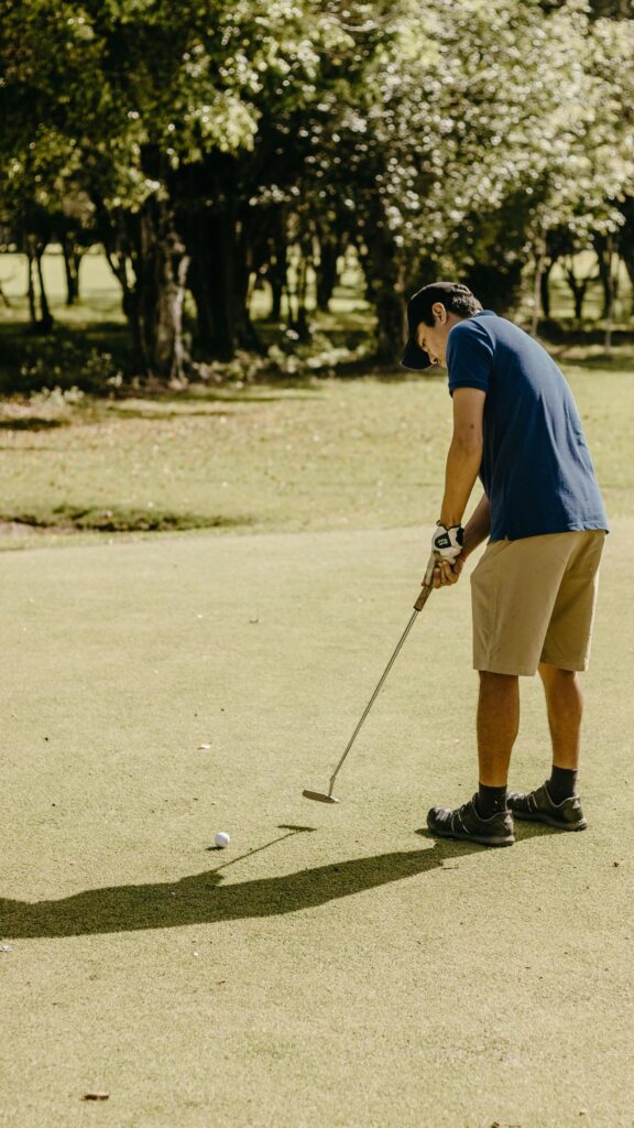 Focused Golfer Putting on Green High-Resolution Mobile Wallpaper