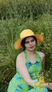 Woman in Green Tropical Dress and Yellow Sun Hat Summer Portrait Wallpaper