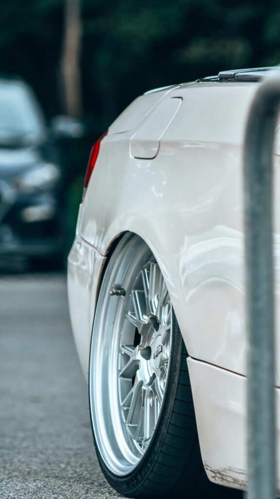 Stanced White Luxury Car Rear Fender and Alloy Wheel Wallpaper