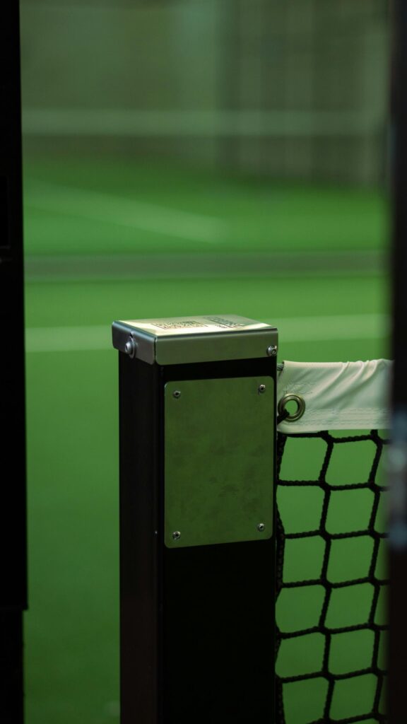 Minimalist Padel Court Net Post with Green Court View Mobile Wallpaper
