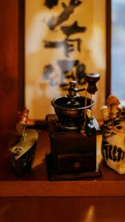 Vintage Coffee Grinder and Lucky Cat Still Life Mobile Wallpaper