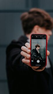 Creative POV Photography of a Person Holding a Phone Mobile Wallpaper