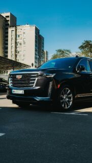 Black Cadillac Escalade Luxury SUV Parked in Urban City Wallpaper