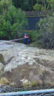 Adventurous Abseiling on a Rocky Cliffside Mobile Wallpaper