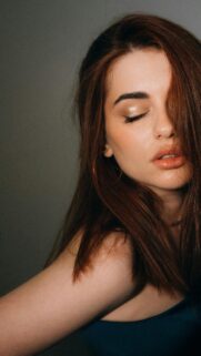 Elegant Woman With Soft Makeup and Auburn Hair Mobile Wallpaper