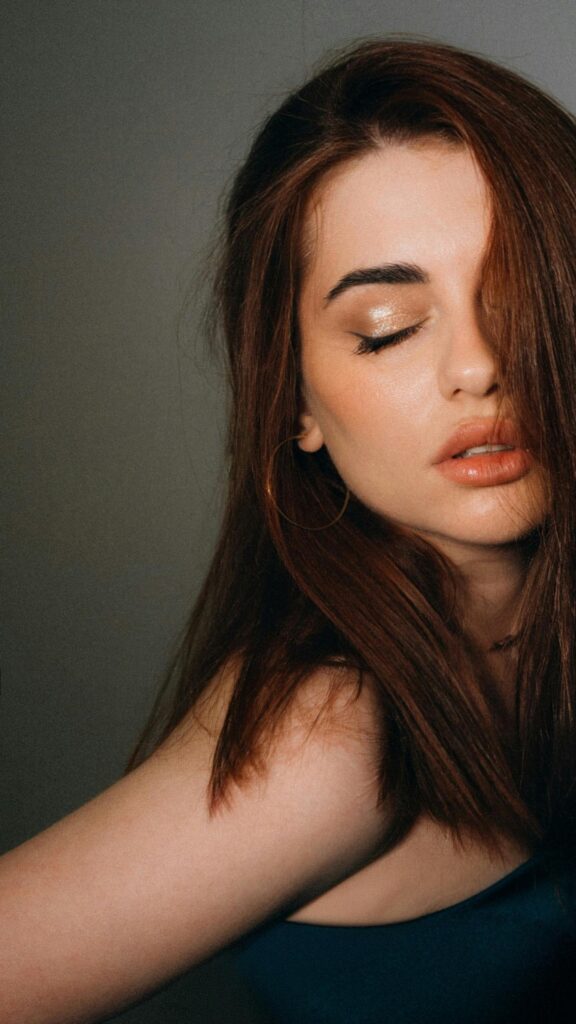 Elegant Woman With Soft Makeup and Auburn Hair Mobile Wallpaper