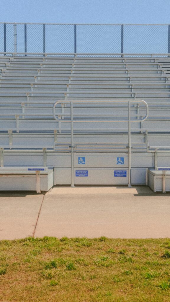 Empty Stadium Bleachers with Accessible Seating Mobile Wallpaper
