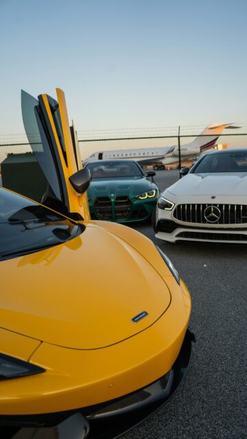 Luxury Sports Cars and Private Jet at Airport Sunset Wallpaper