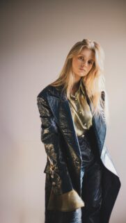 Chic Blonde Model in Navy Patent Leather Coat Aesthetic Phone Wallpaper