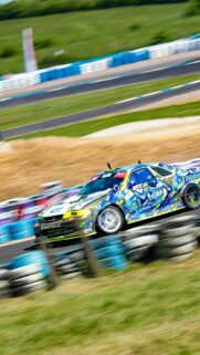 Drifting Nissan Skyline R33 Sports Car Racing Action Wallpaper