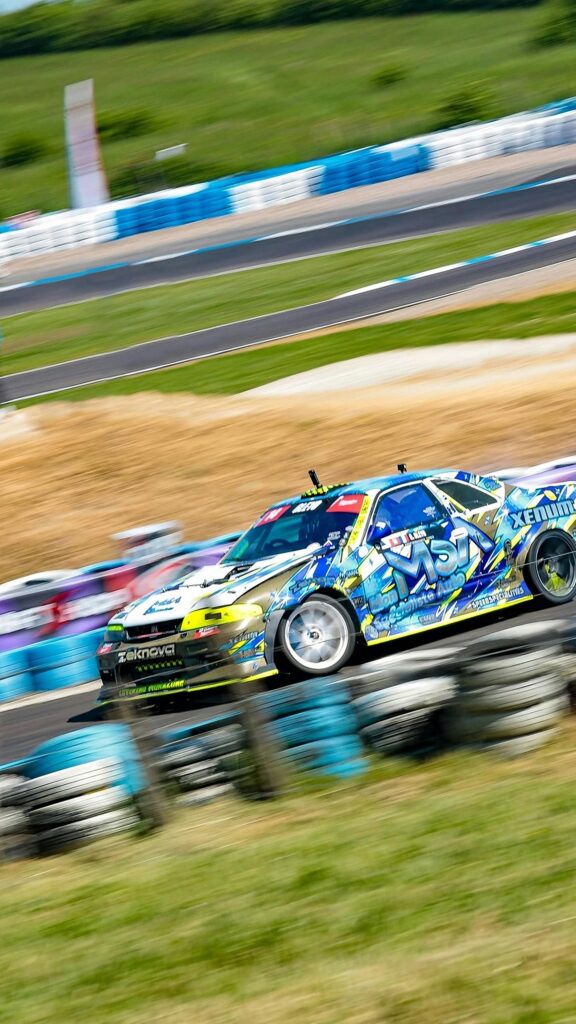 Drifting Nissan Skyline R33 Sports Car Racing Action Wallpaper