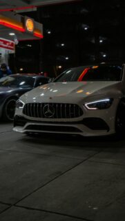 Stunning White Mercedes-AMG GT 4-Door Coupe at Gas Station Wallpaper