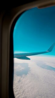 Airplane Wing Above Clouds Sky Blue View Mobile Wallpaper