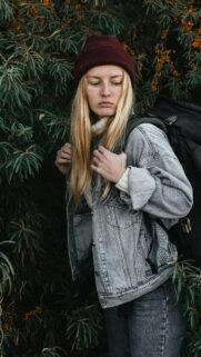 Blonde Hiker in Denim Jacket and Maroon Beanie Outdoor Wallpaper